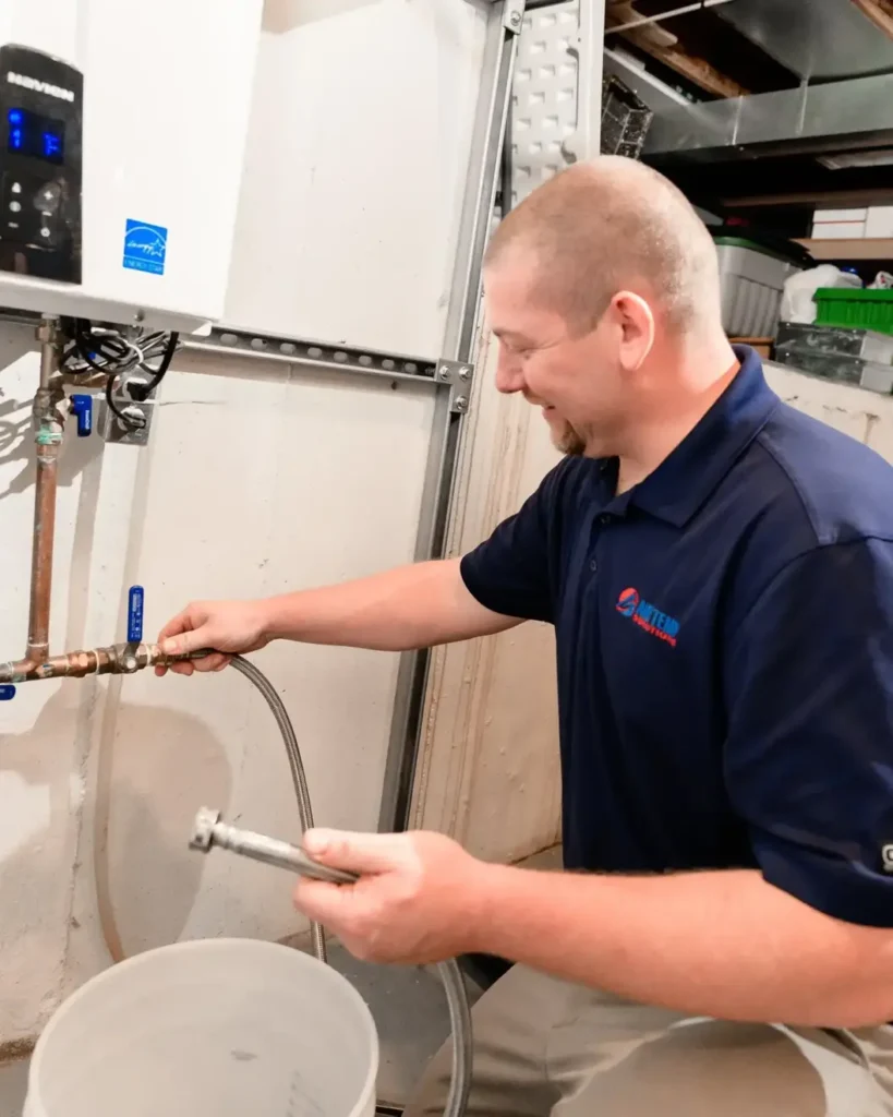 Air Temp tech performing repairs on a tankless water heater