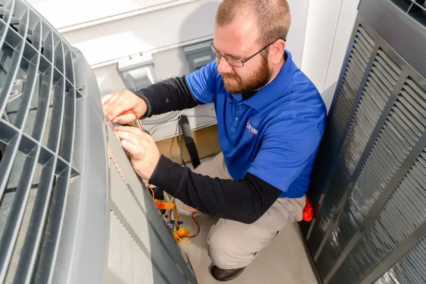 Air Temp tech performing services on an outdoor A/C unit