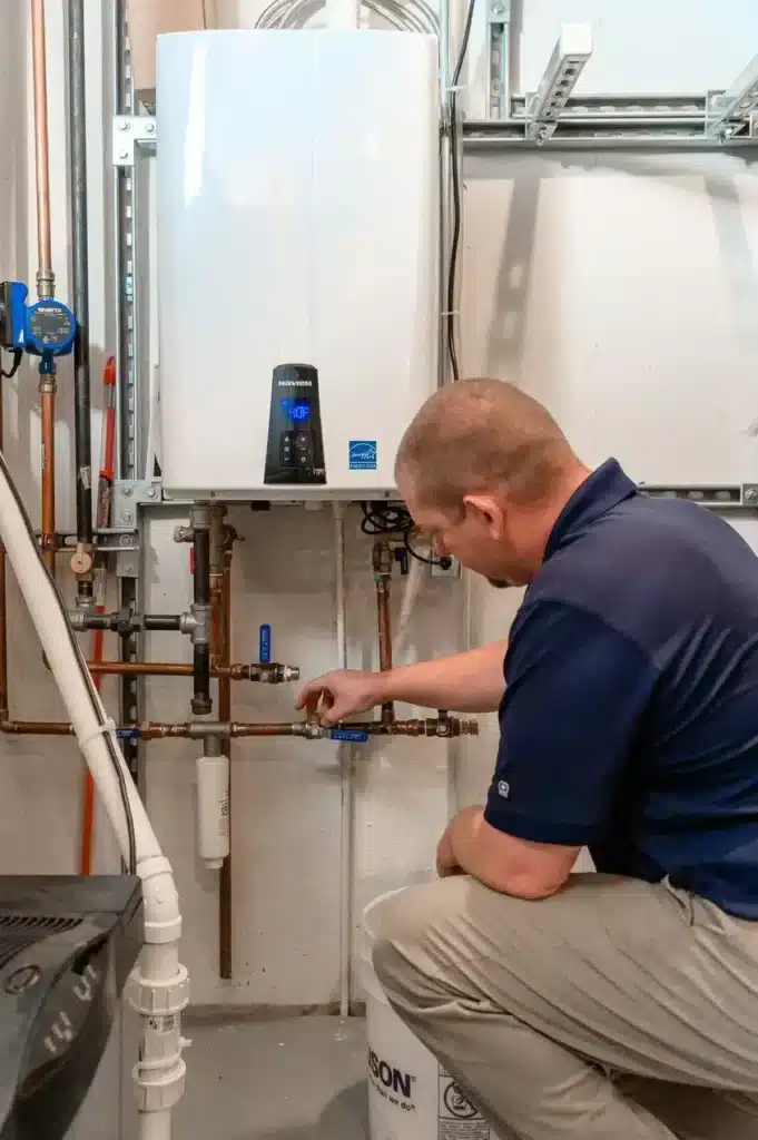 Air Temp tech performing routine tankless water heater maintenance