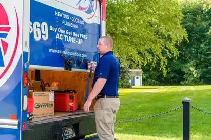Air Temp technician opening back of van.