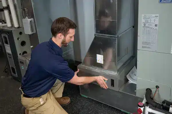 technician putting furnace panel back