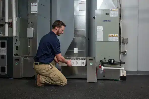 technician changing air filters for furnace