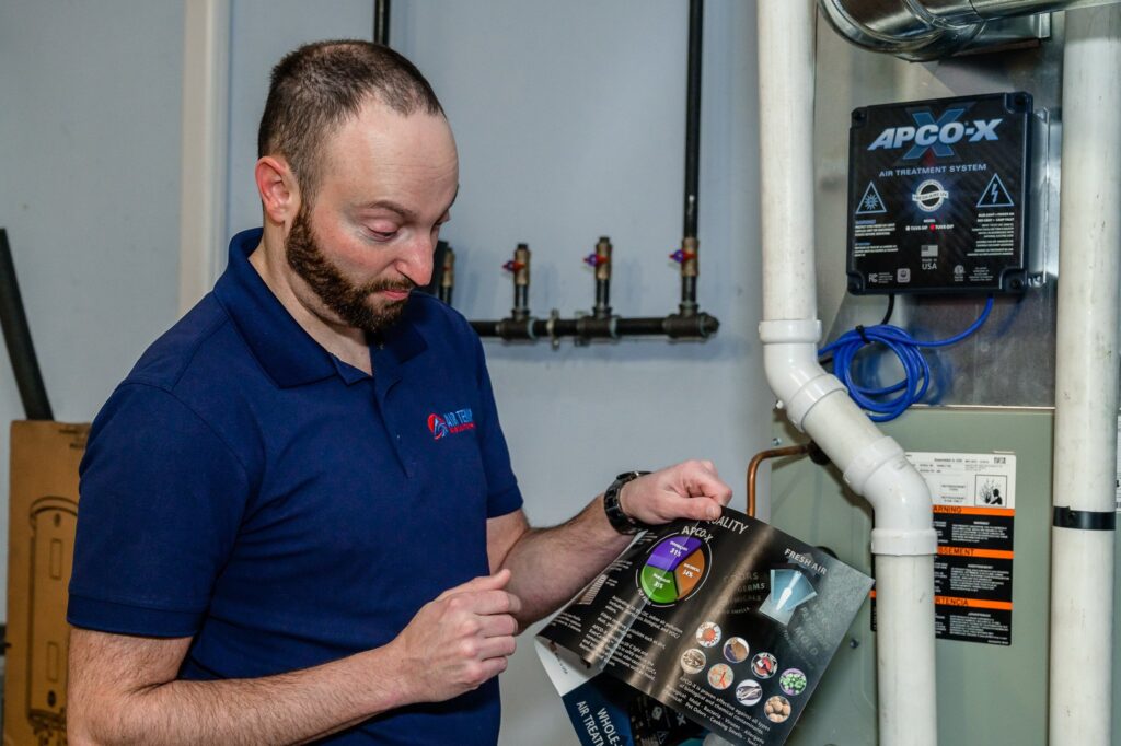Air Temp employee explaining the benefits of an air filtration system