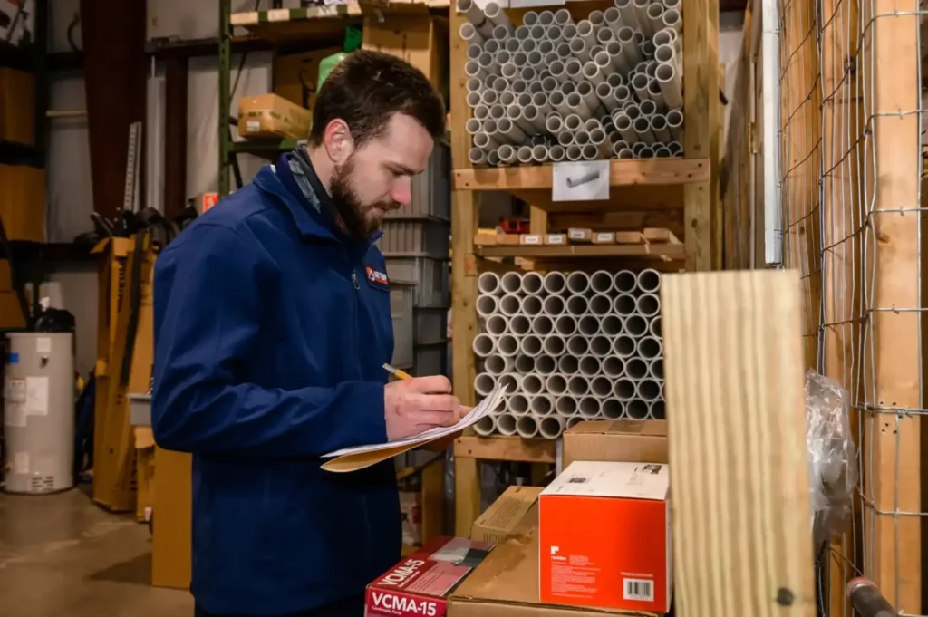 Air Temp Solutions technician writing down information during inspection