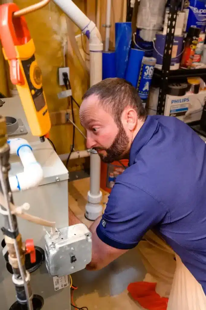 Air Temp Tech performing regular maintenance on an indoor heating system
