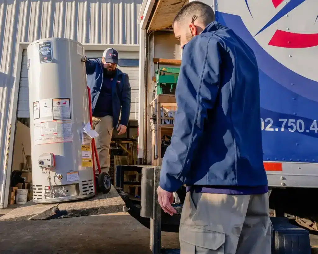 Air Tech Solutions technicians unloading a new water heater from van
